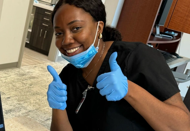 medical assistant reviewing items under a microscope