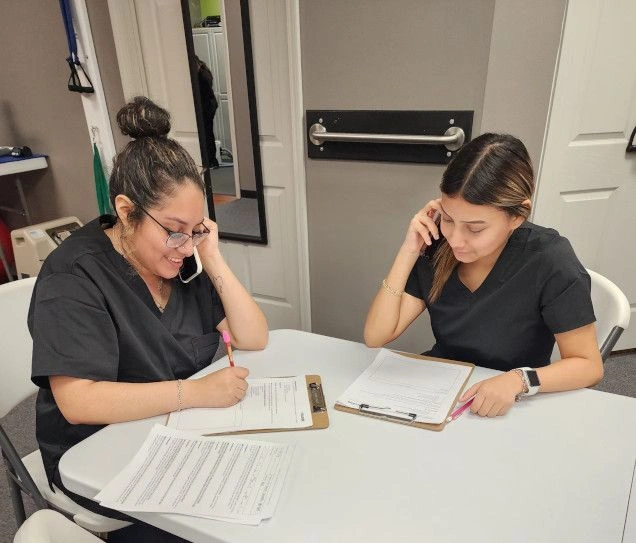 Medical students filling out documents for patients